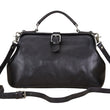 Load image into Gallery viewer, Black leather handbag with a strap on a light background