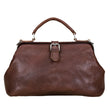 Load image into Gallery viewer, Brown leather handbag on a light wooden surface