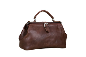 Brown leather handbag on a light wooden surface
