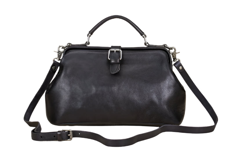 Black leather handbag with a strap on a light background