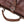 Load image into Gallery viewer, Brown leather bag with metal hardware on a light wooden surface
