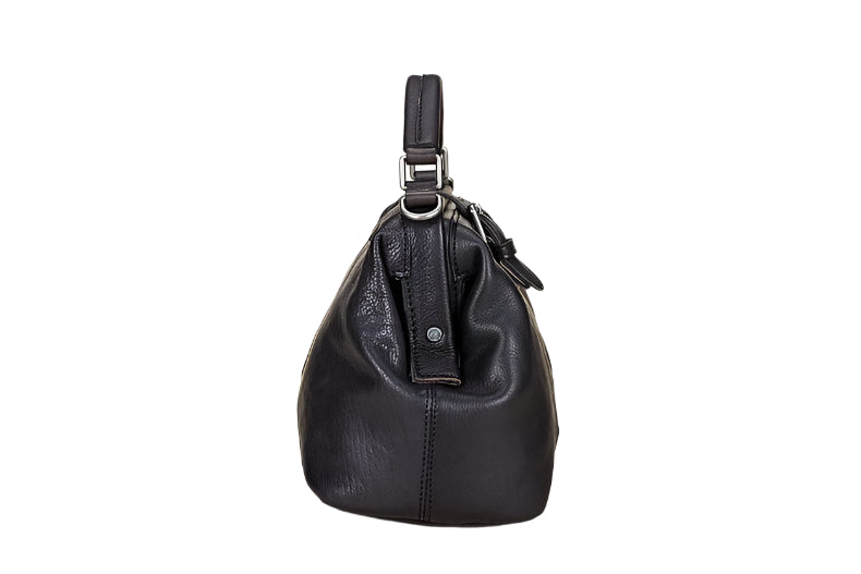 Black leather handbag on a light wooden surface