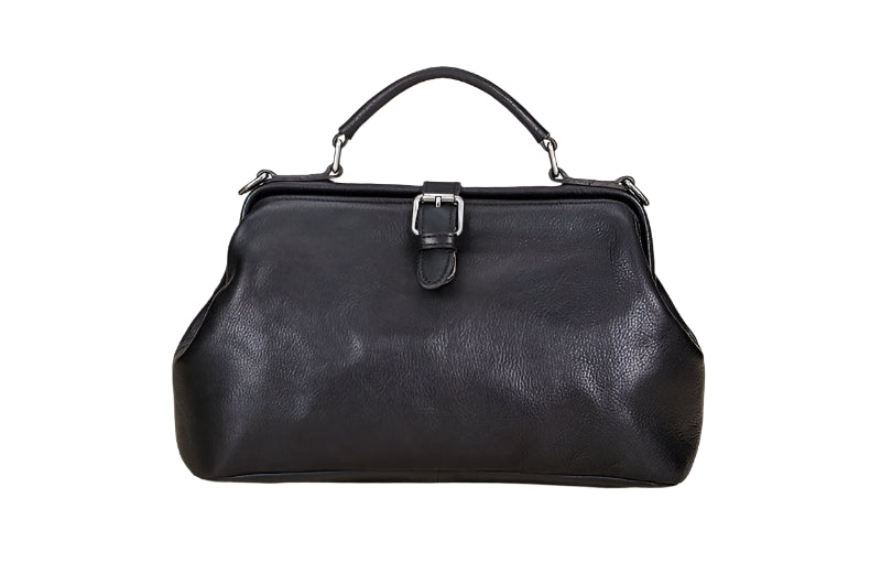 Black leather handbag on a light wooden surface