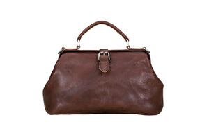 Brown leather handbag on a light wooden surface