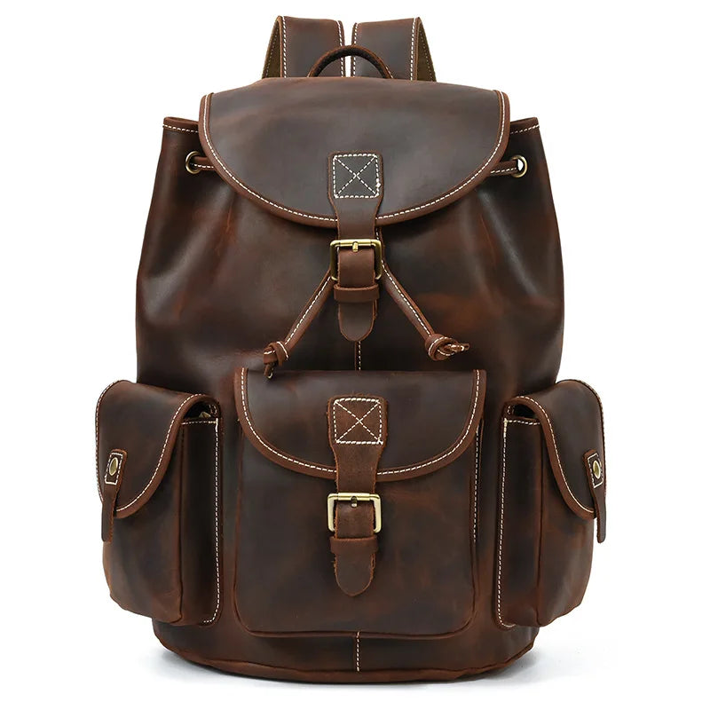 Brown leather backpack with gold buckles on a white background