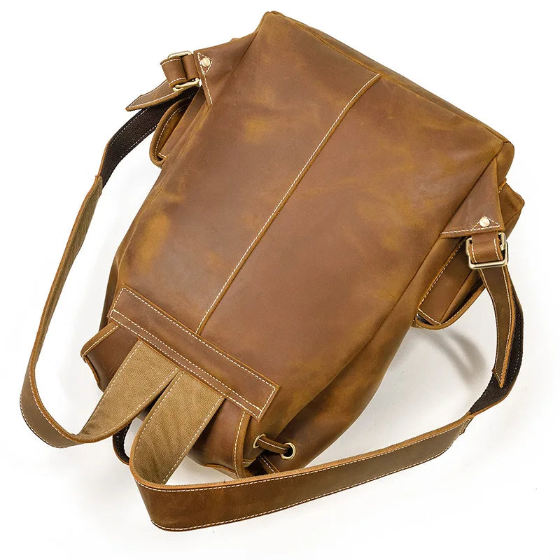 Brown leather bag with a strap on a white background