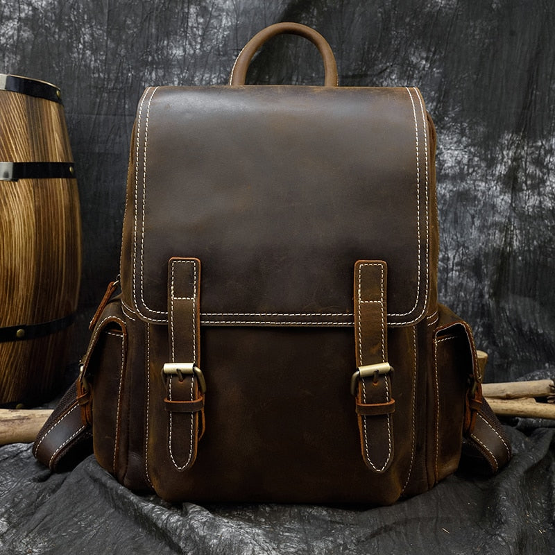 Brown Leather Backpack next to a Beer Drum